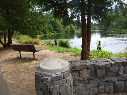 Bench on natural surface over-looks river – near interpretive displays and meteorite replica